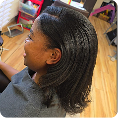 A young girl who has had her natural hair treated and blown out