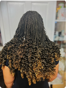 Back view of a woman with knotless braids done at Tete Hazel