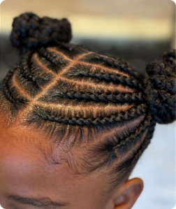 A kid who got cornrows at Tete Hazel