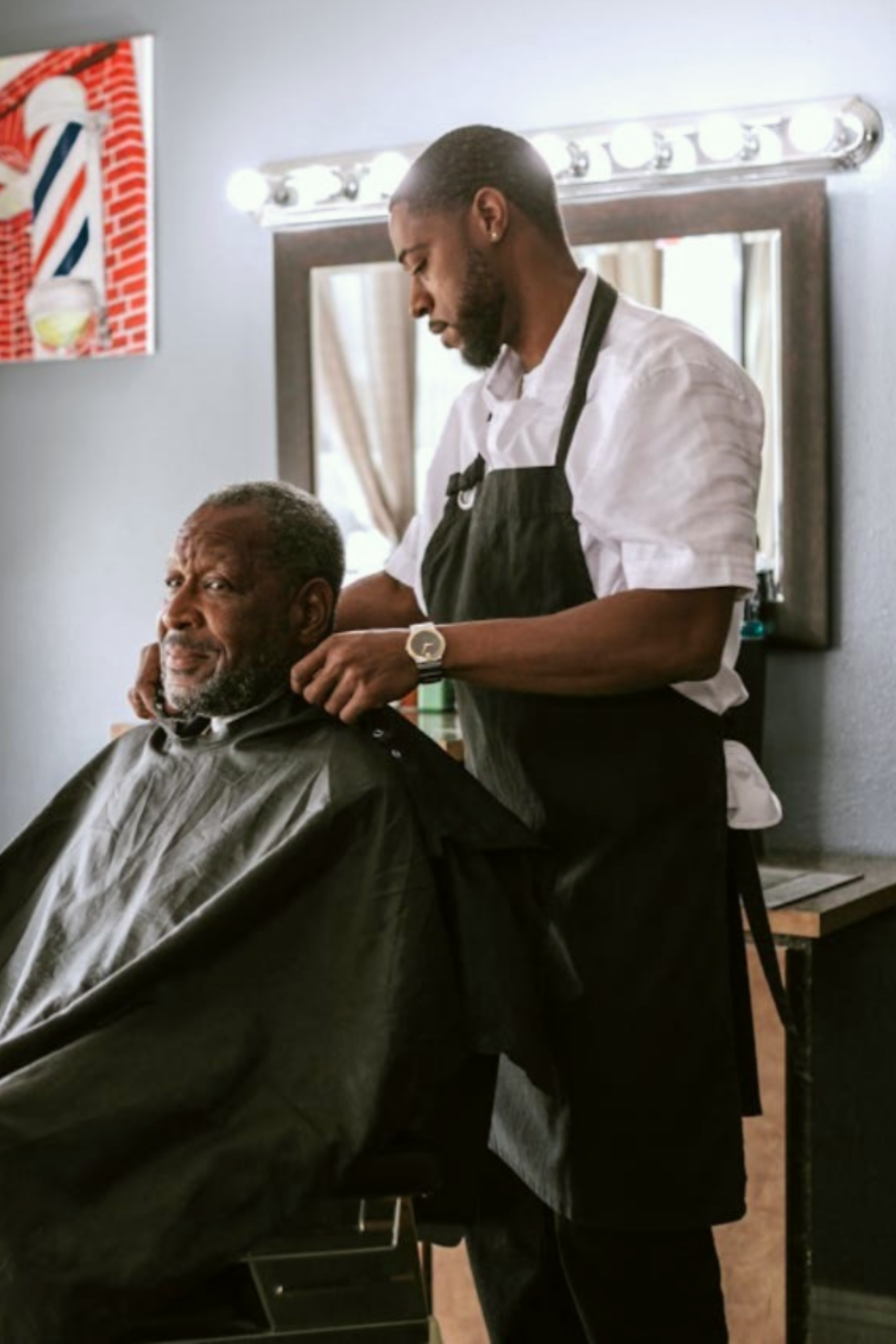 A barber preparing to cut a man's hair