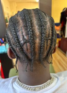 A man with stylish cornrows
