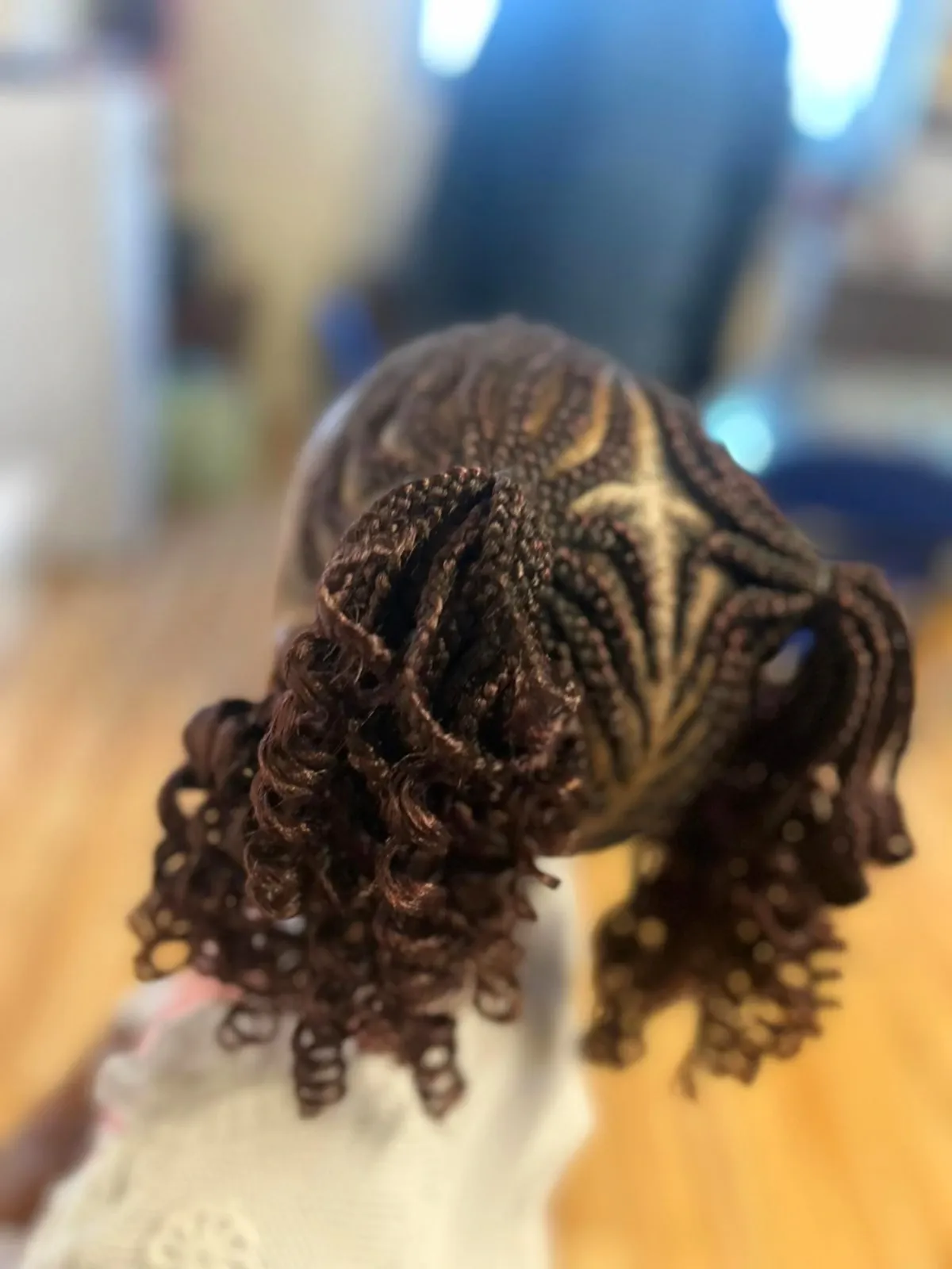 a child with cornrow braids hairstyle done at Tete Hazel