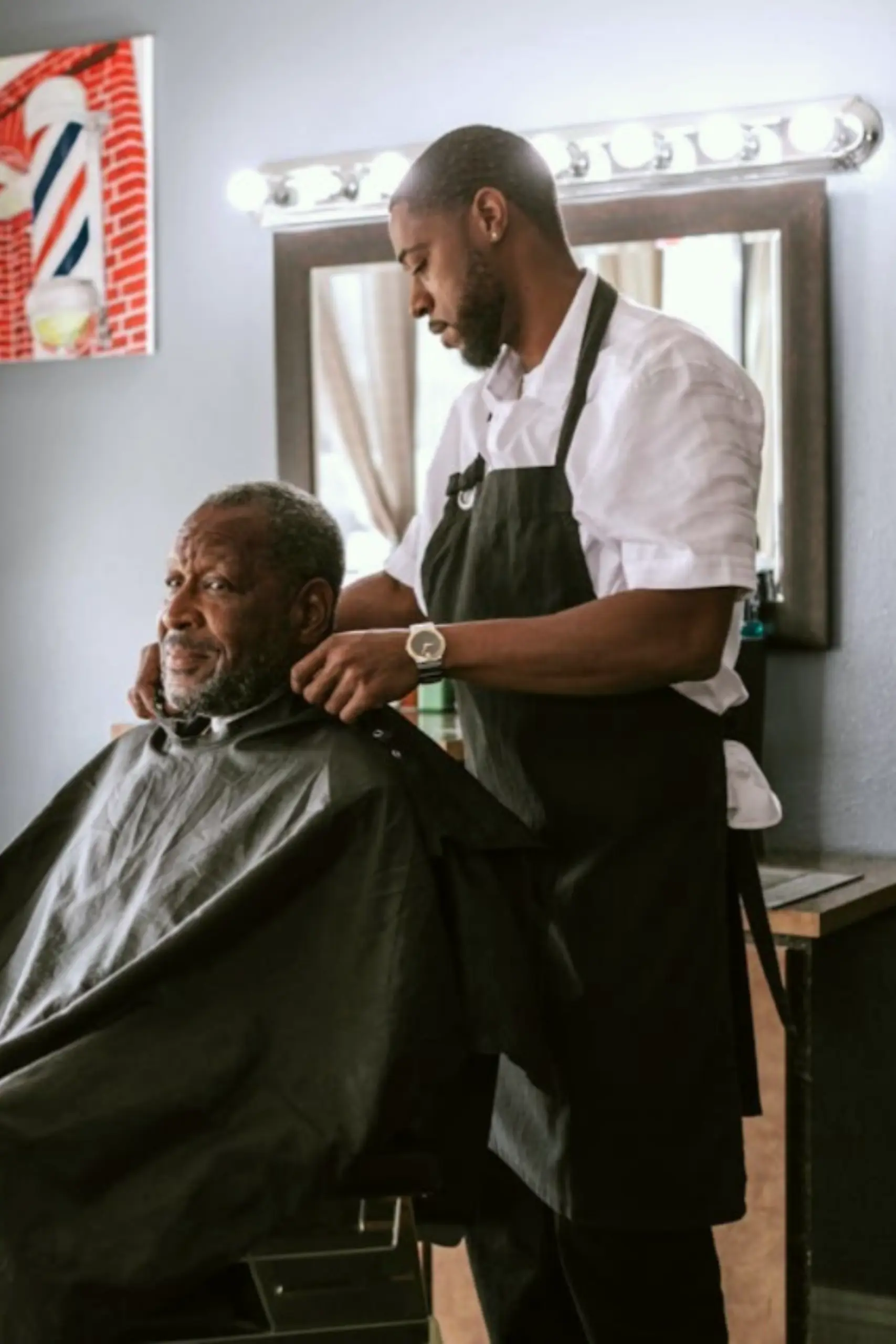 A barber preparing to cut a man's hair