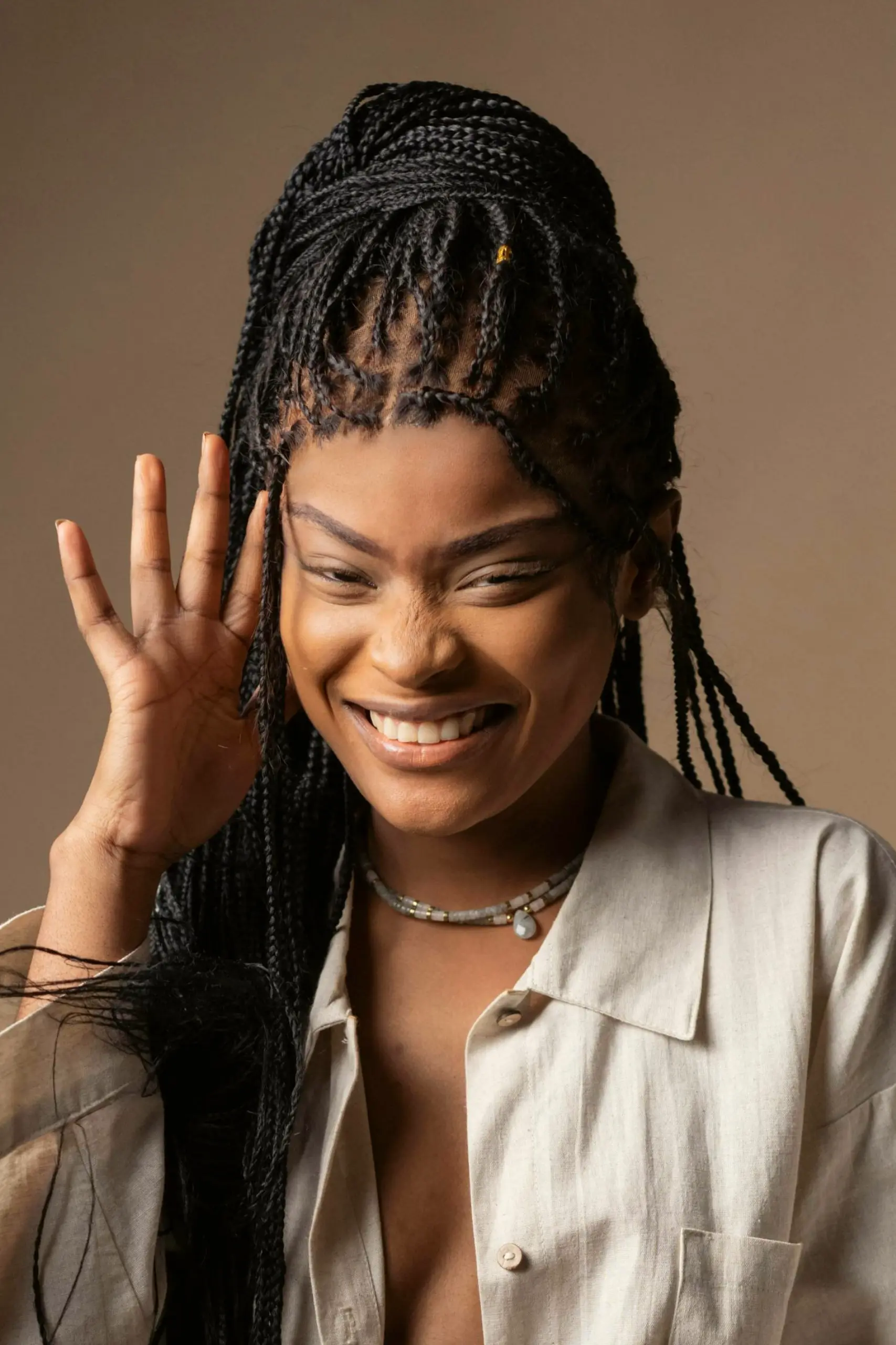 A woman with make up done smiling into the camera